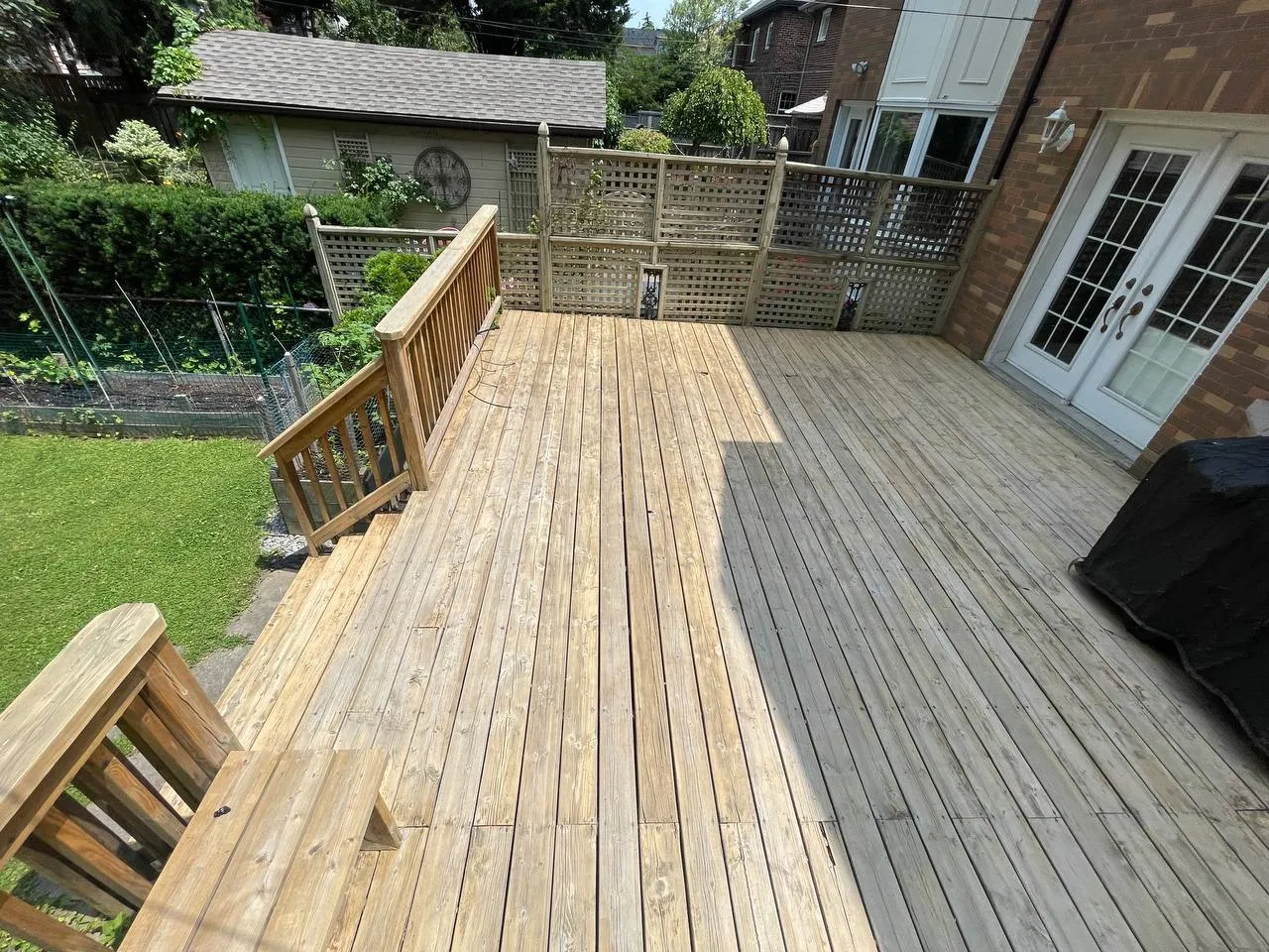 Deck staining prep on a North York backyard deck by Co Painting