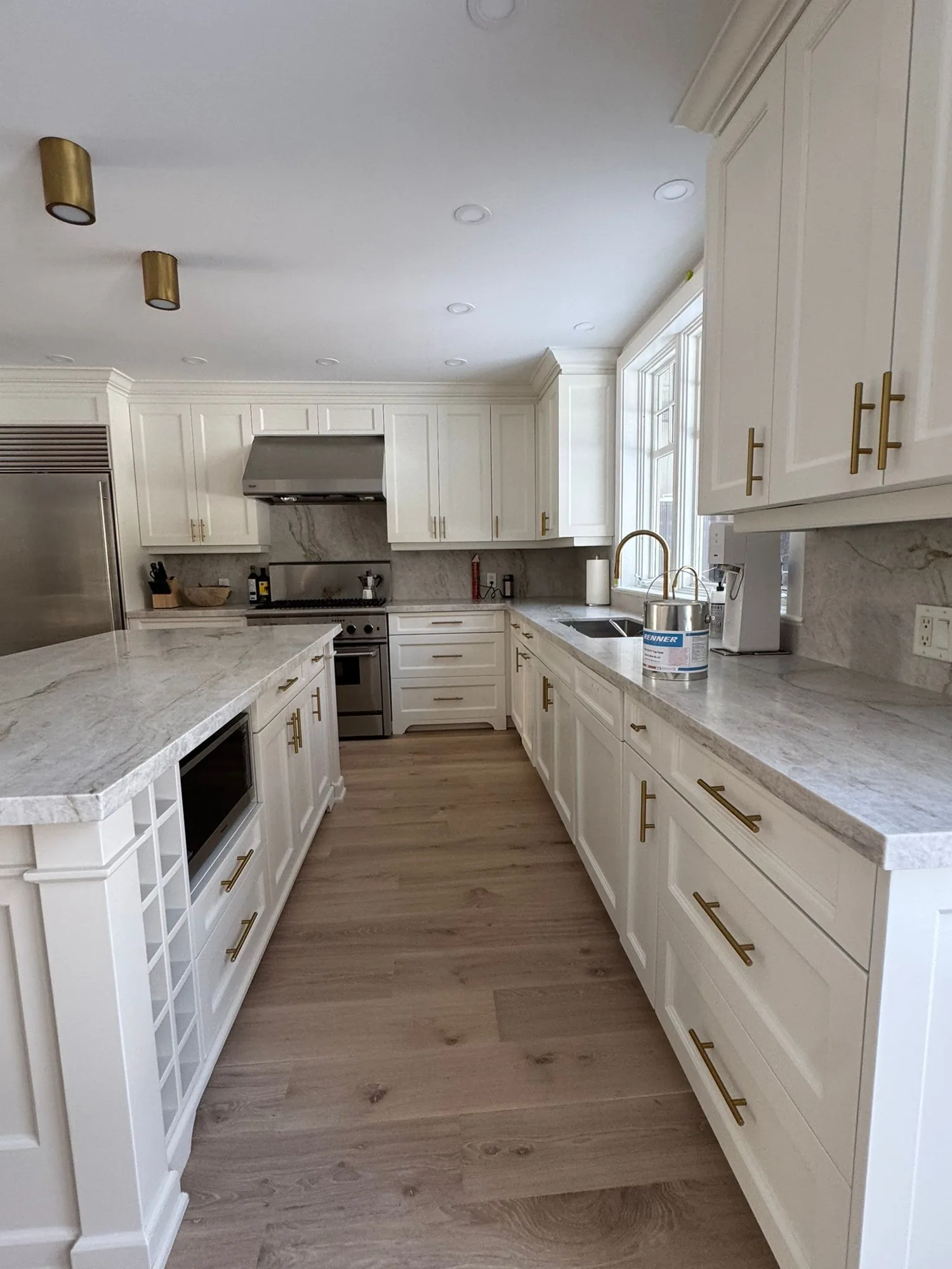 Sprayed white kitchen cabinets in a Toronto home by Co Painting